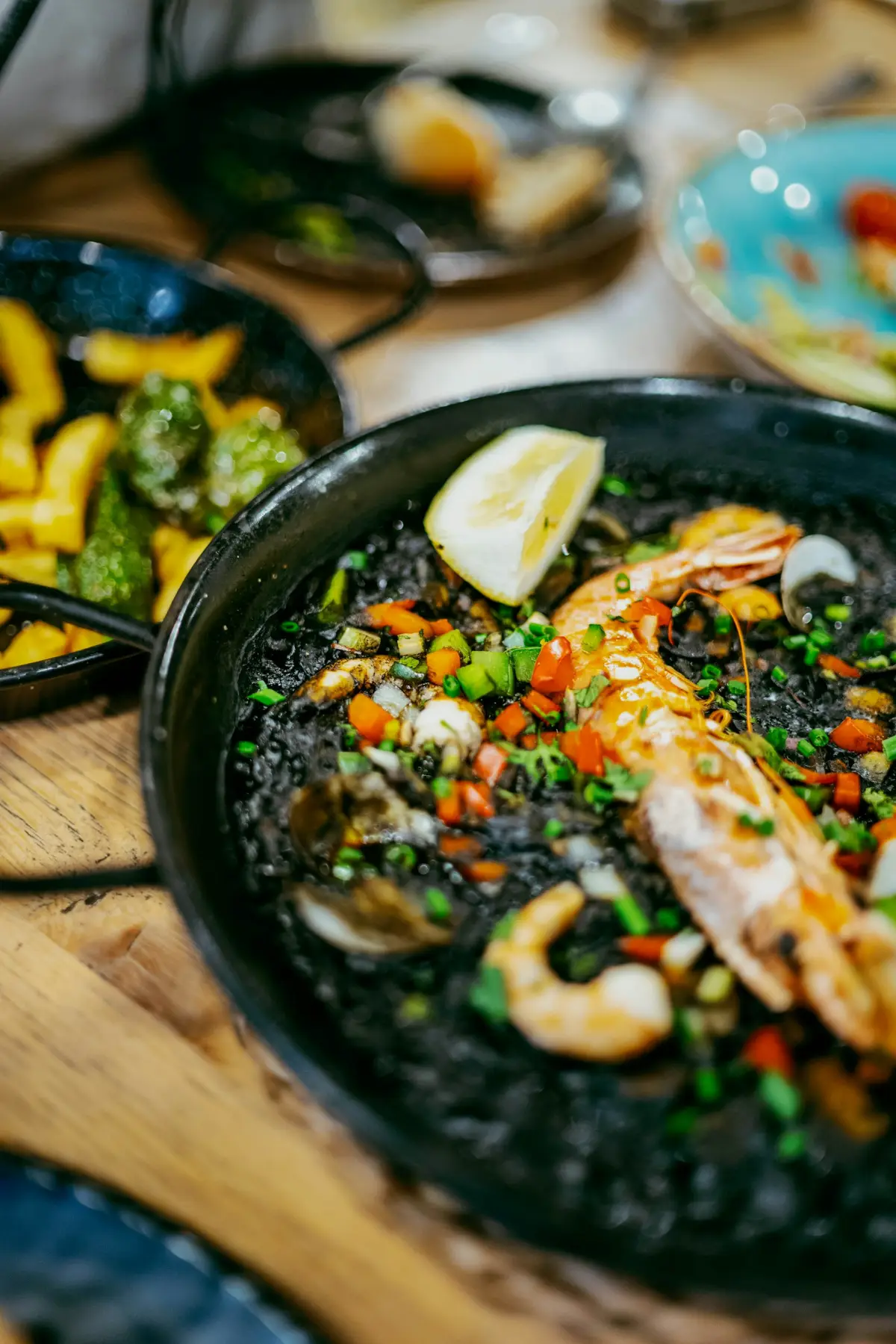 Black rice paella with prawns and lemon
