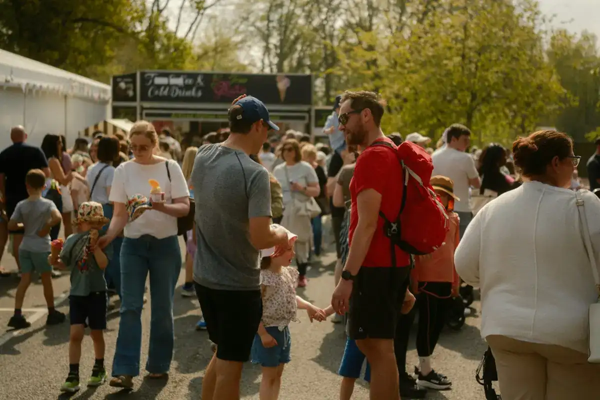 Crowds walking between food stalls at an outdoor food festival